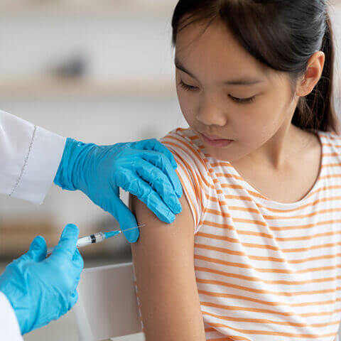 A girl receiving a vaccination shot